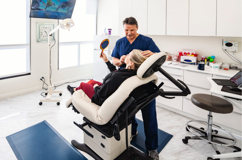 Dr. Joe Cerni consulting with patient with mirror